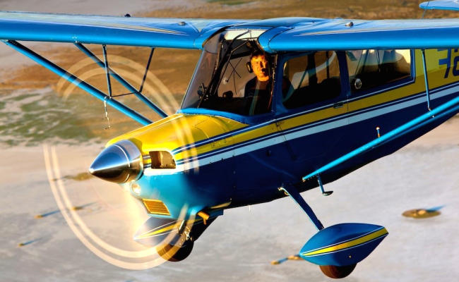 small blue airplane in flight aircraft appraisal