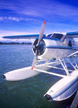 a radial engine airplane on floats to be appraised